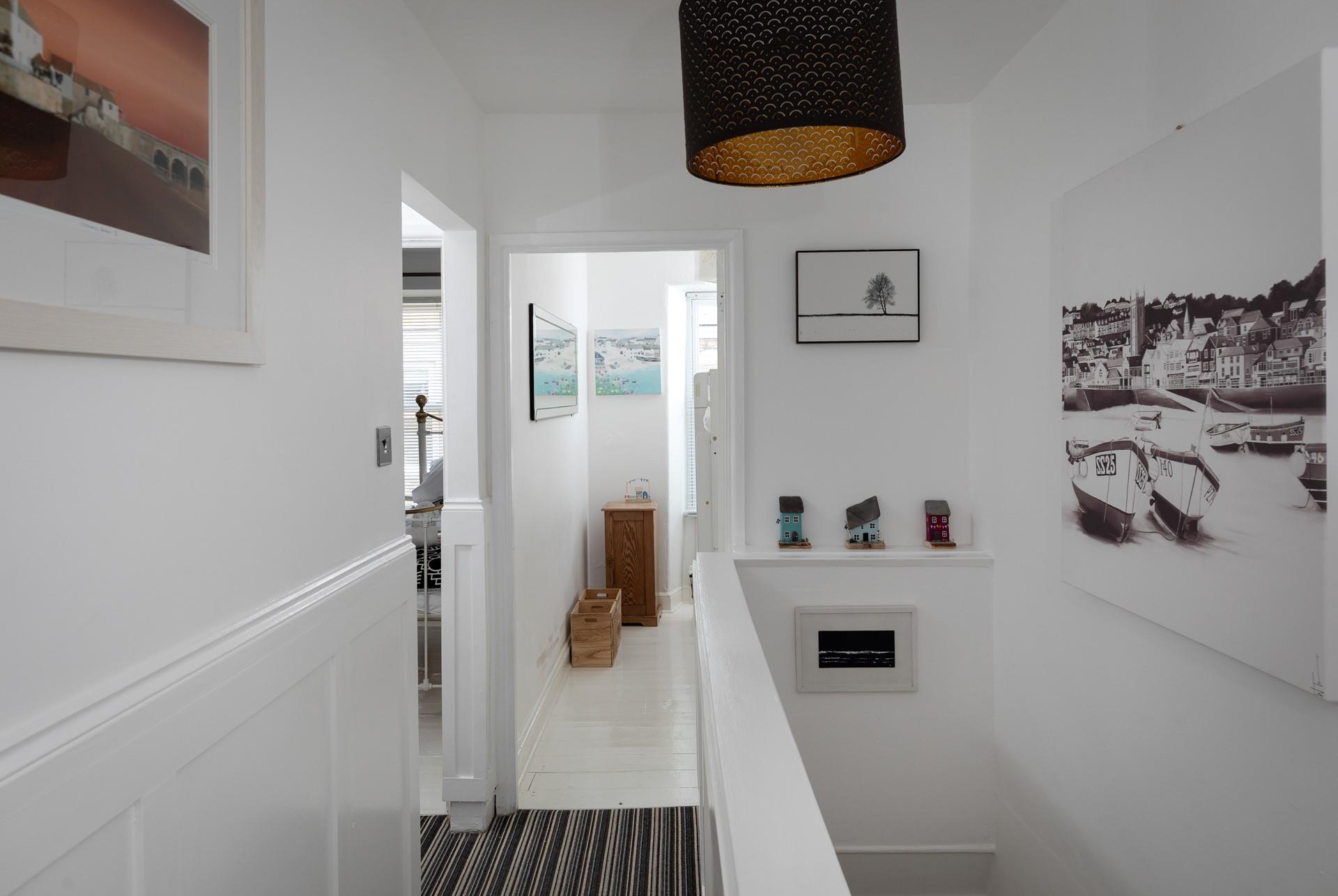 The artwork on the walls features scenes of St Ives.