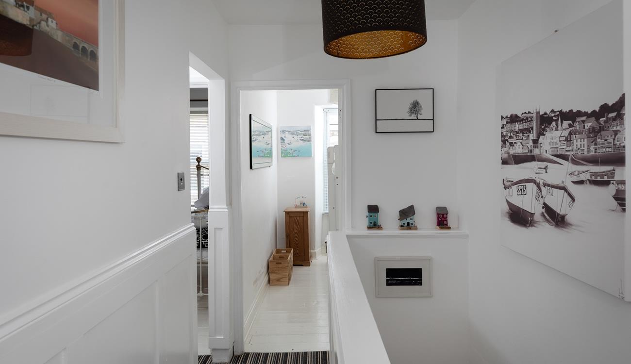 The artwork on the walls features scenes of St Ives.