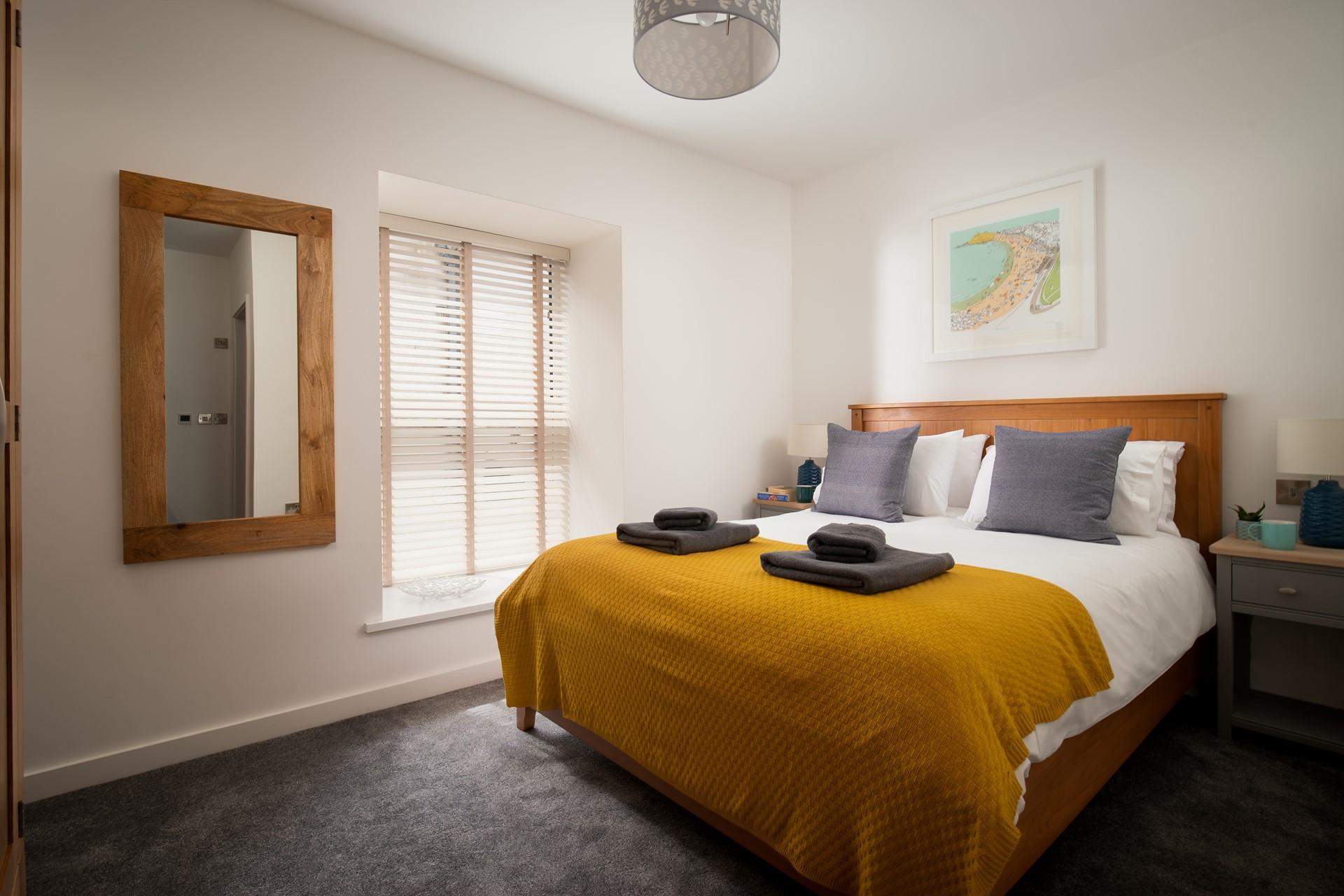 Bedroom 1 has a large, comfortable bed that will leave you well-rested and ready for the day ahead.