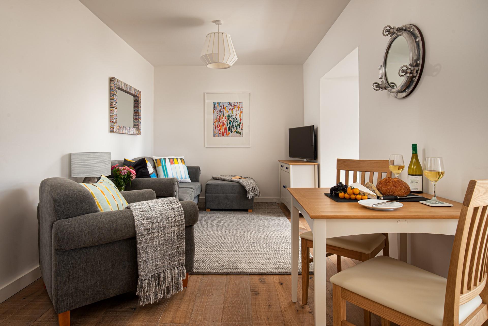 Compact yet cosy, the lovely open plan living space is filled with soft tones and classic furniture, creating a real home from home feel.