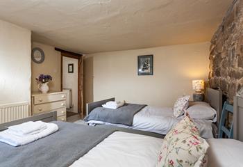 The charming twin bedroom boasts lovely cottage features.