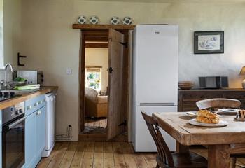 The rustic door from the kitchen diner leads into the family sitting room. 