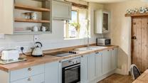 The kitchen is modern with everything needed to prepare and cook tasty meals.