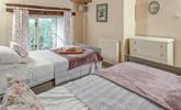 Classic cottage features create a beautifully serene bedroom. - Thumbnail Image