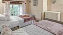 Classic cottage features create a beautifully serene bedroom.
