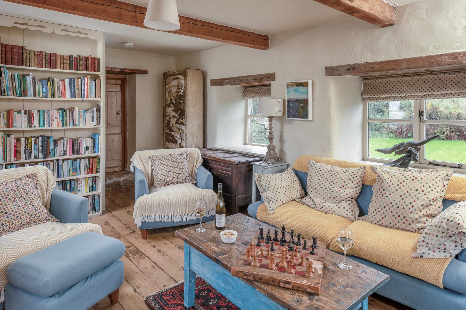 The cosy sitting room is full of character with exposed beams and traditional furnishings.