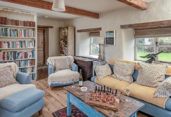 The cosy sitting room is full of character with exposed beams and traditional furnishings.