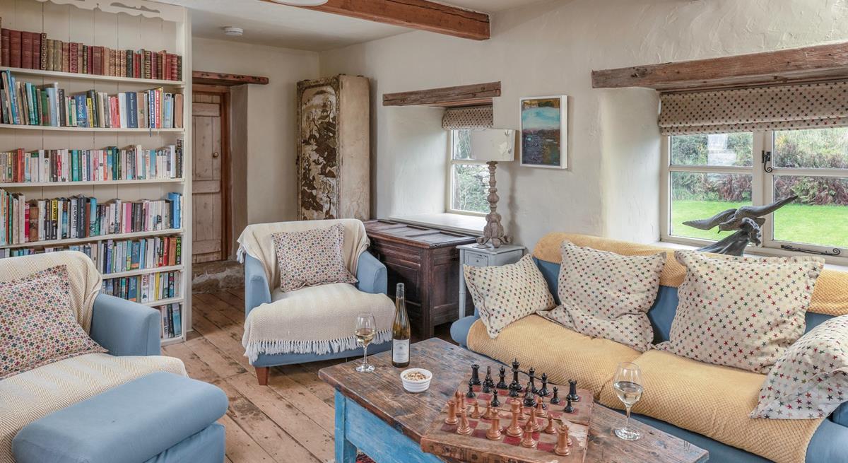 The cosy sitting room is full of character with exposed beams and traditional furnishings.