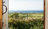 Open the front door to let the sunshine into the hut, you have the best of both worlds with views of countryside and sea. - Thumbnail Image