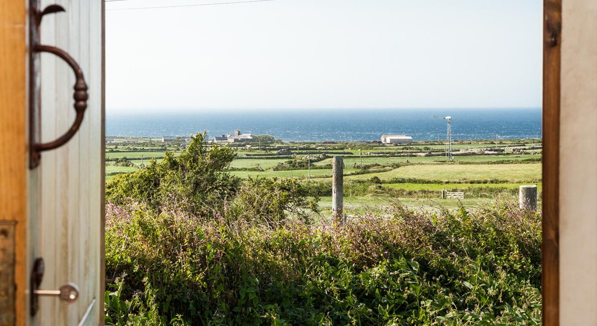 Open the front door to let the sunshine into the hut, you have the best of both worlds with views of countryside and sea.