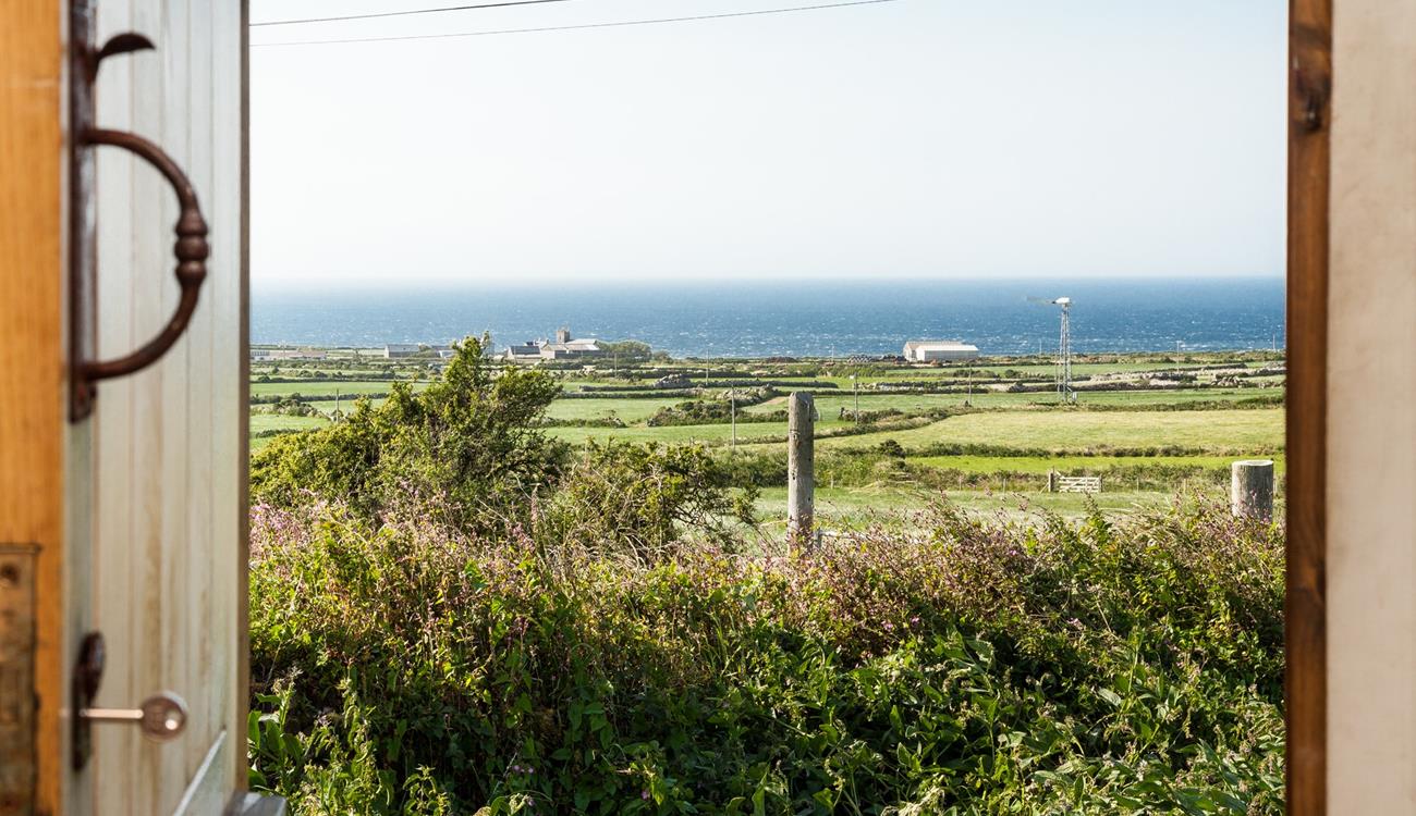Open the front door to let the sunshine into the hut, you have the best of both worlds with views of countryside and sea.