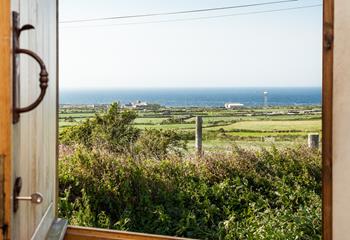 Open the front door to let the sunshine into the hut, you have the best of both worlds with views of countryside and sea.