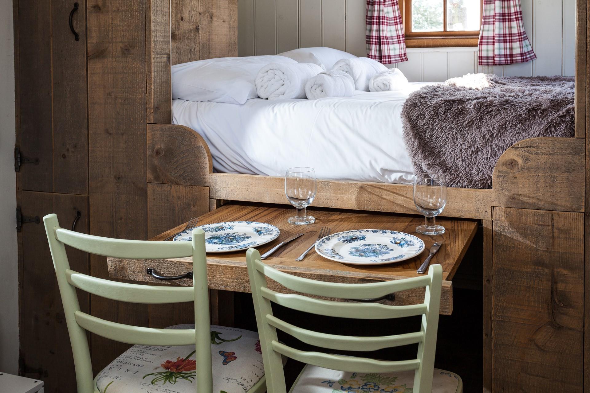 The pull-out dining table is perfect for enjoying a romantic meal for two.