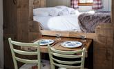 The pull-out dining table is perfect for enjoying a romantic meal for two. - Thumbnail Image