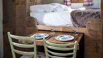 The pull-out dining table is perfect for enjoying a romantic meal for two.