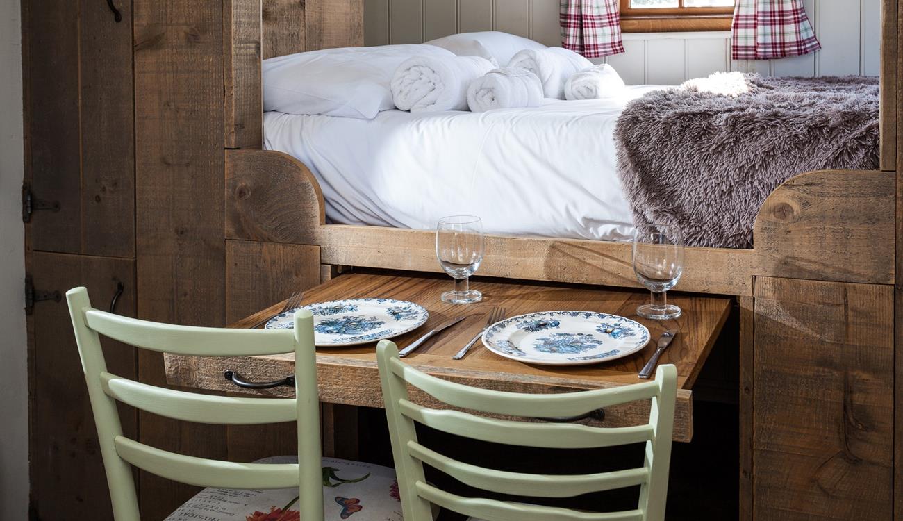The pull-out dining table is perfect for enjoying a romantic meal for two.
