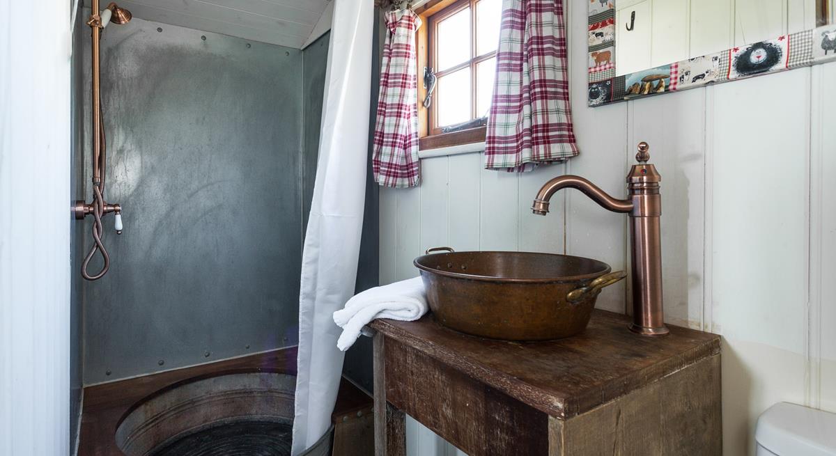 The shower room adds to the quirky and rustic finish - the shower tray is made from an old tin bath!