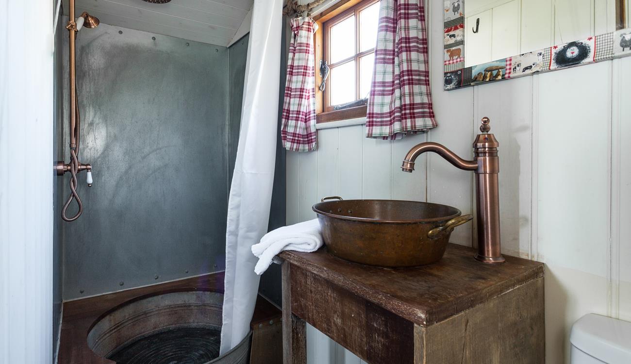 The shower room adds to the quirky and rustic finish - the shower tray is made from an old tin bath!