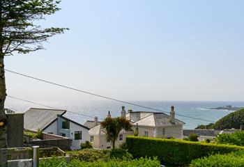 On a sunny day, the sea glistens in the distance.