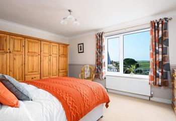 Bright, warm colours ensure the bedroom is a welcoming space to retire to at the end of a busy day!