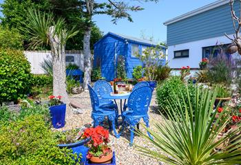 Bright and colourful furniture adorns the garden. 