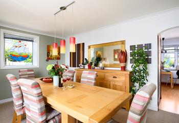 We love the warm colours, interesting artwork and stylish lights in the dining room. 