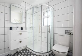 The bathroom is sleek and stylish, perfect for starting your morning with an invigorating shower.