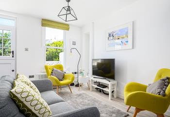 The contemporary living space is wonderfully bright with pops of colour.