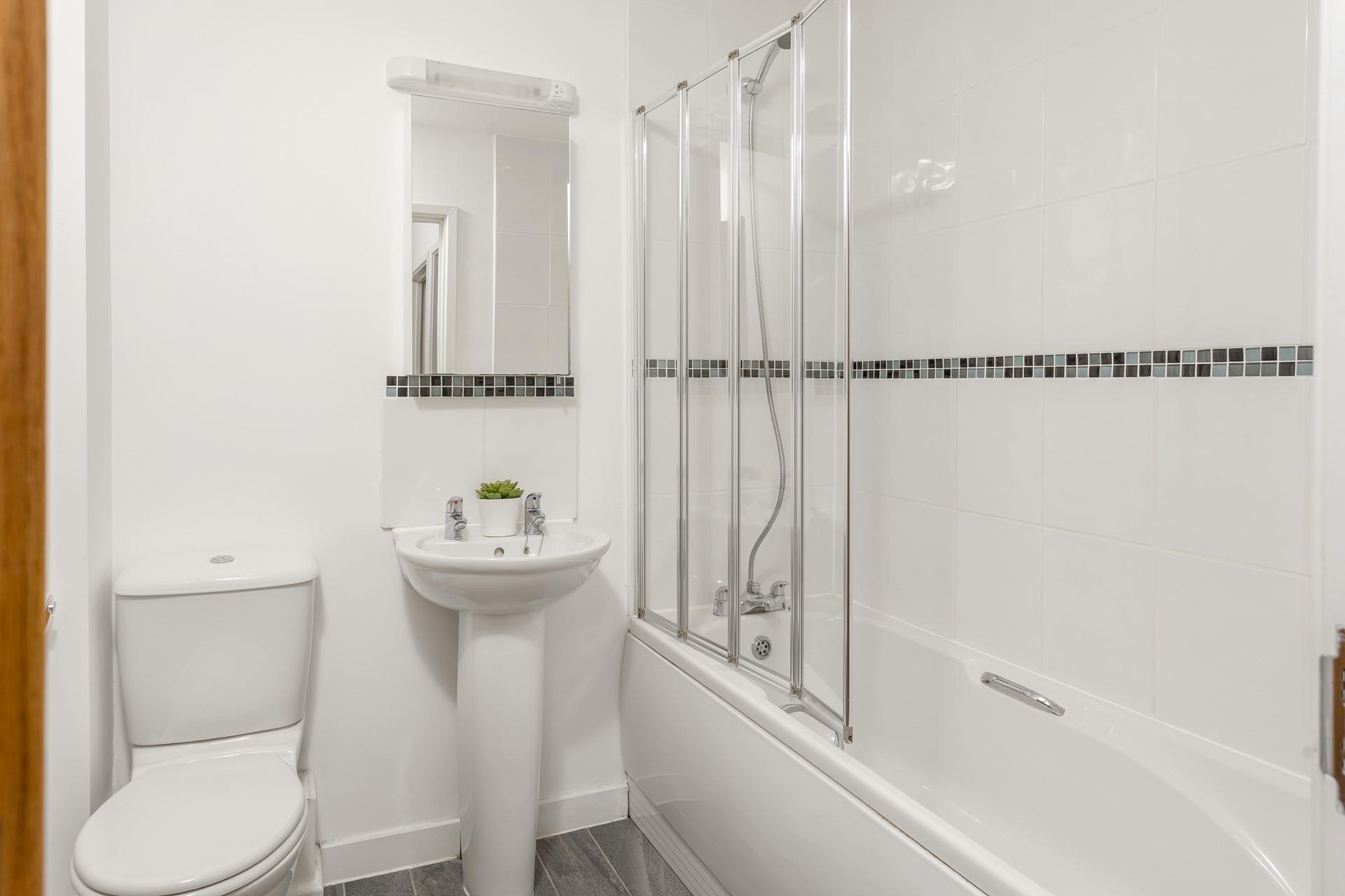 The family bathroom is on the first floor between bedrooms three and four and benefits from a bath and shower. 
