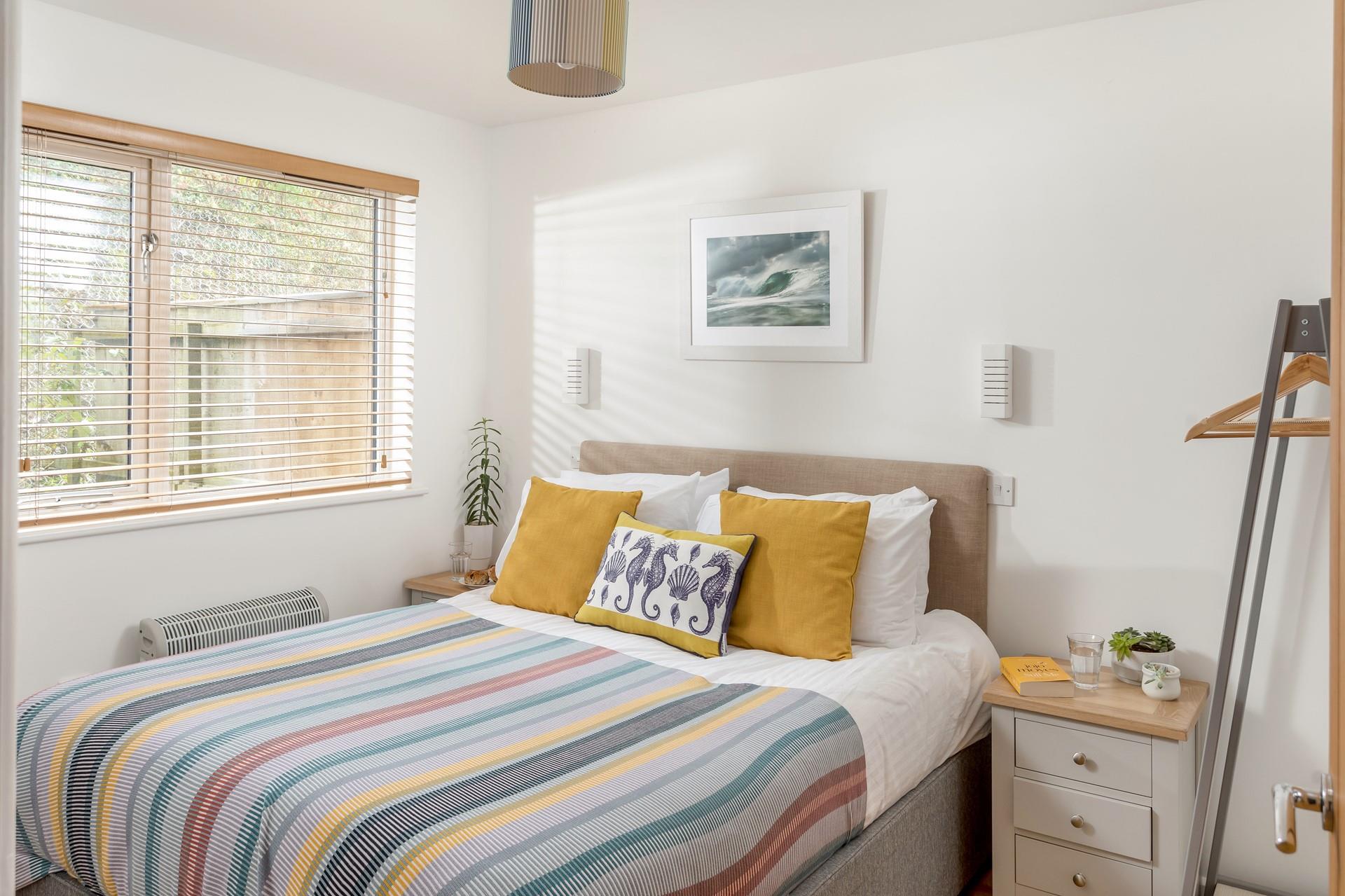 Modern furnishings, fun pops of colour and a sumptuous bed make this room a comfortable space to unwind before bed.