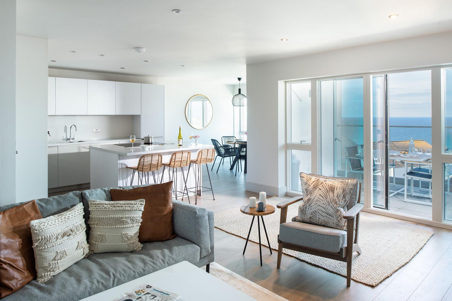 The open plan living area leads out to the balcony and stunning sea views.
