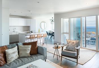 The open plan living area leads out to the balcony and stunning sea views.