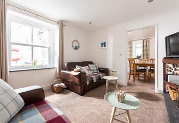 Natural light fills the room from the large sash window. 