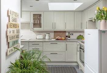 The kitchen is modern and stylish for preparing and cooking meals.