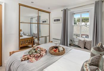 Large, mirrored wardrobes maximise space and light in the master bedroom.