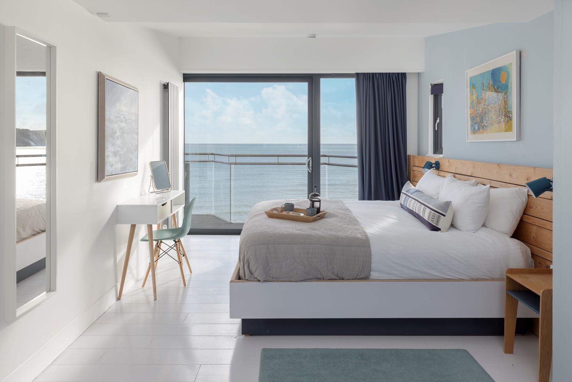 Open the curtains and watch the sunrise over the sea.