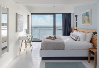 Open the curtains and watch the sunrise over the sea.