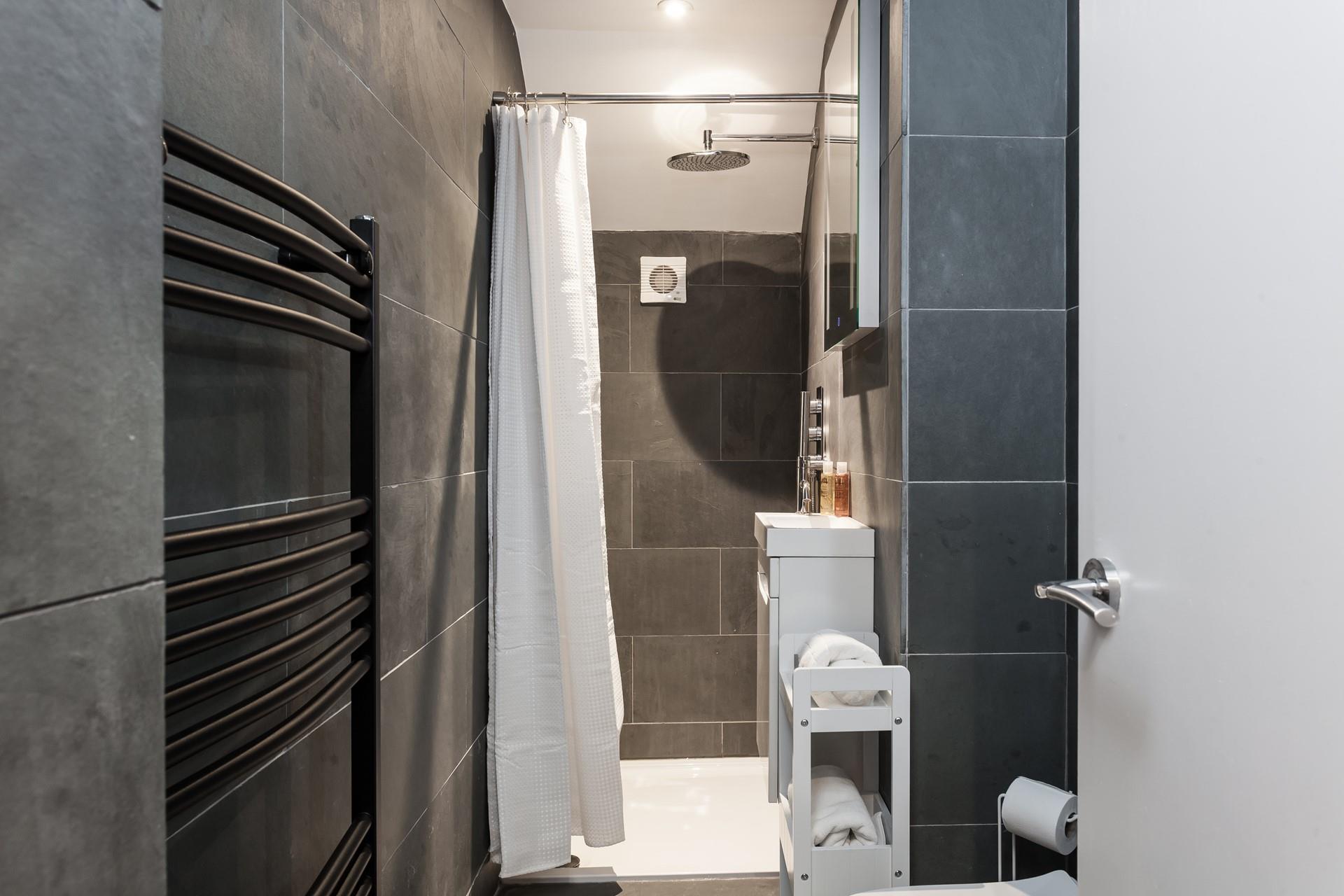 Although compact, the modern en suite provides space to get ready each morning.