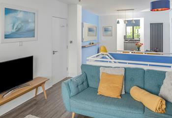 The open plan living space is stylishly finished with a sea theme.