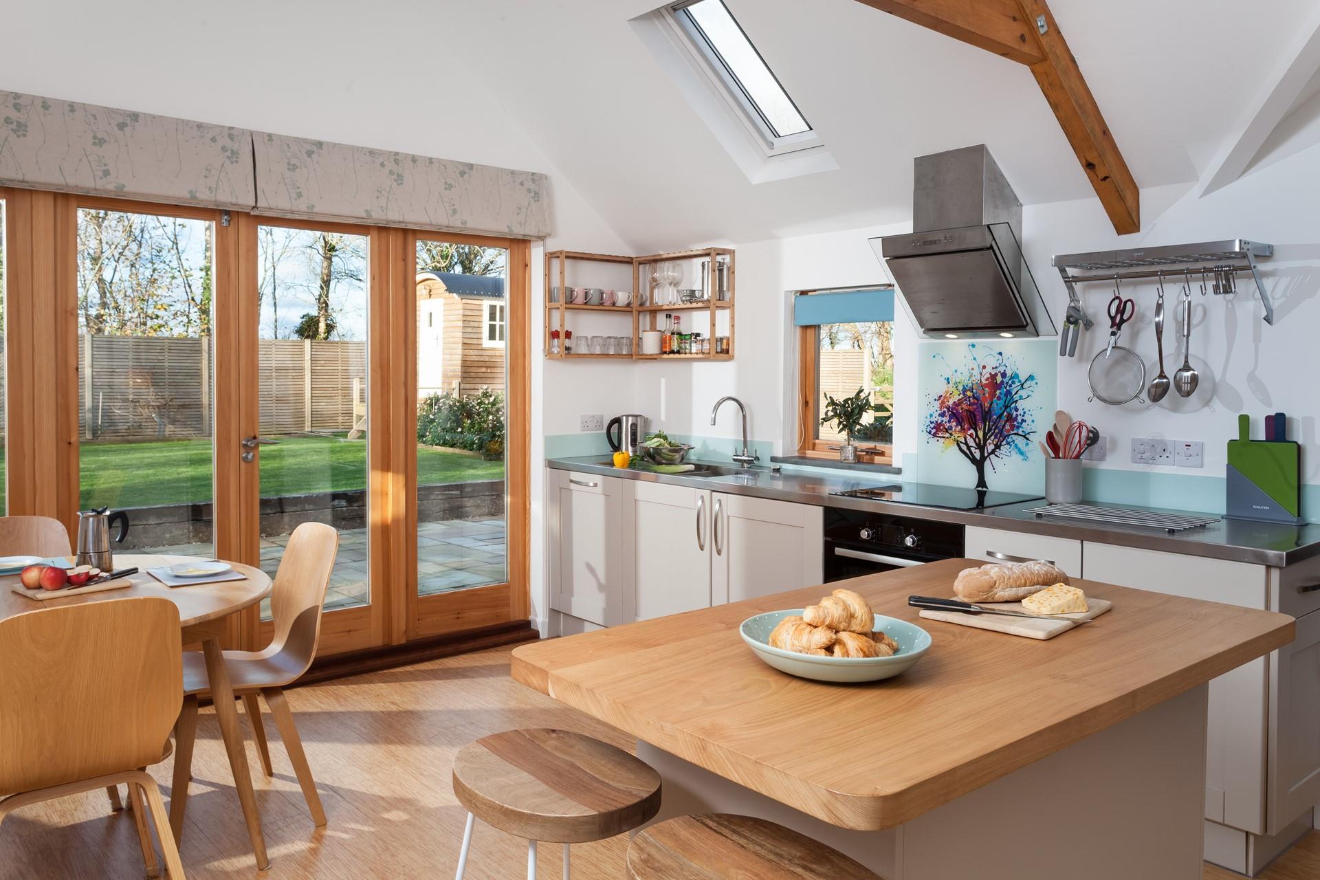 Open plan living space overlooking the Shepherd's Hut and garden.