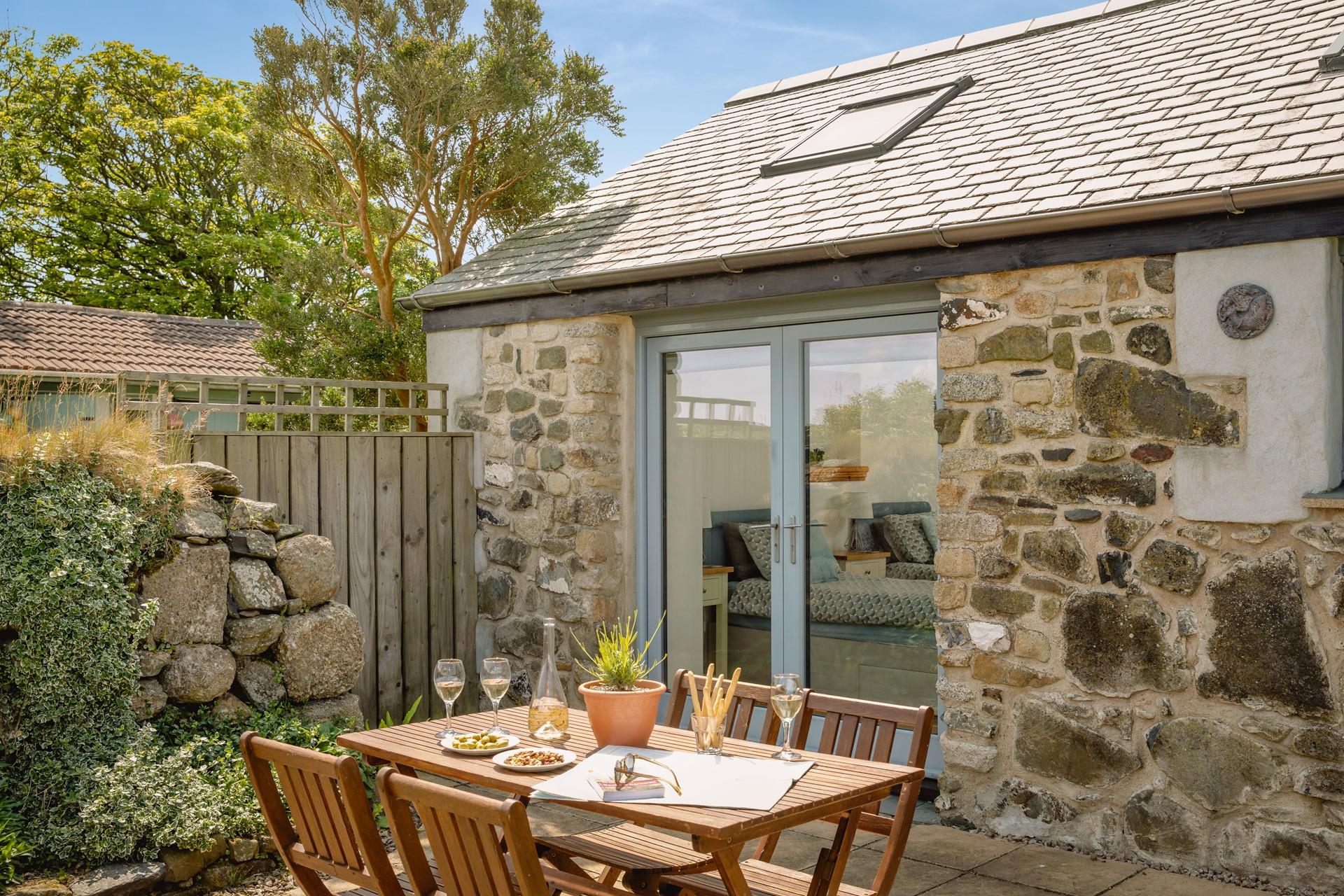 Sip a glass of wine and soak up the sun and countryside views.