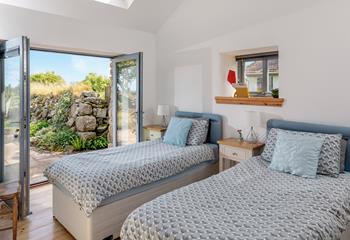 The twin bedroom has doors leading onto the patio, perfect for a morning coffee. 