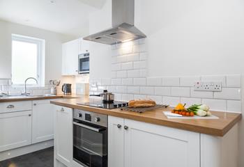 Though compact the kitchen has been cleverly designed to maximise space.