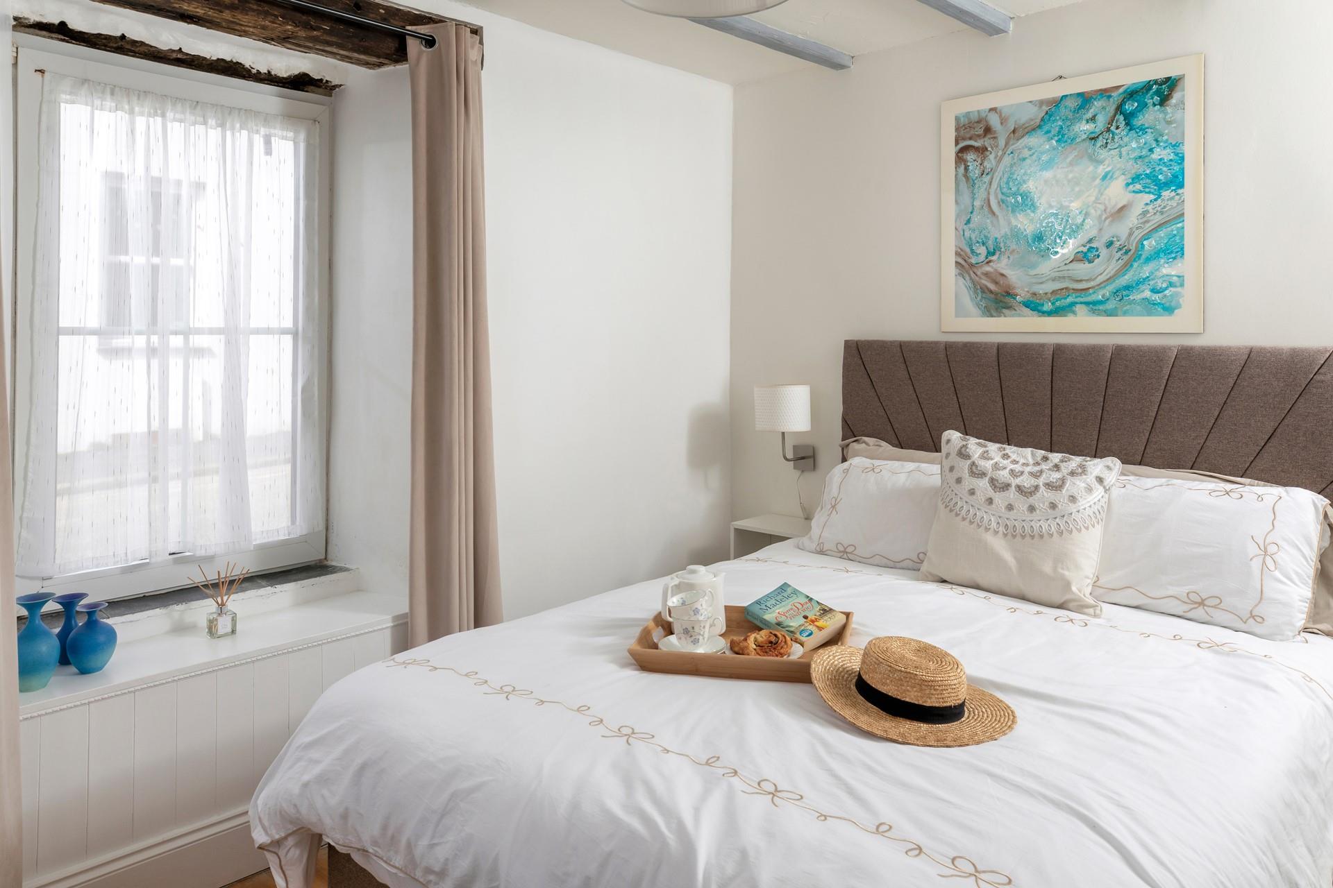 Muted tones and a large, comfortable bed make the bedroom a soothing place to unwind before drifting off to sleep.