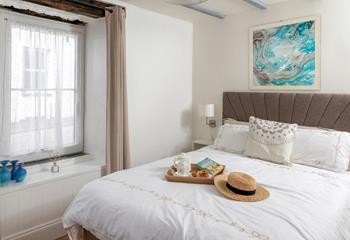 Muted tones and a large, comfortable bed make the bedroom a soothing place to unwind before drifting off to sleep.