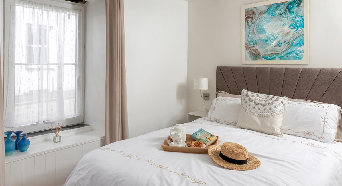 Muted tones and a large, comfortable bed make the bedroom a soothing place to unwind before drifting off to sleep.