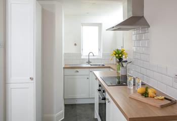 Though compact, the kitchen has been cleverly designed to maximise space.