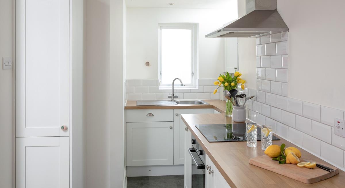 Though compact, the kitchen has been cleverly designed to maximise space.