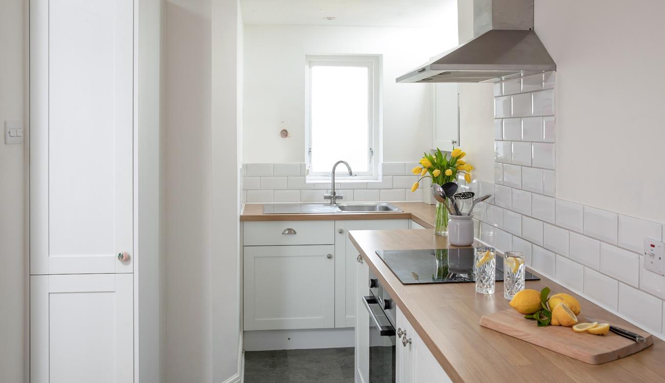Though compact, the kitchen has been cleverly designed to maximise space.