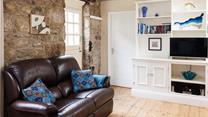 The cottage is full of charm with exposed beams and granite walls.